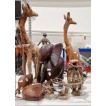 Collection of carved wood African animals including two giraffes, a bone tusked elephant, a large