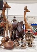 Collection of carved wood African animals including two giraffes, a bone tusked elephant, a large