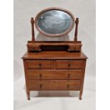 Late Victorian/Edwardian oak dressing chest with oval bevel-edged swing mirror, two jewel drawers,