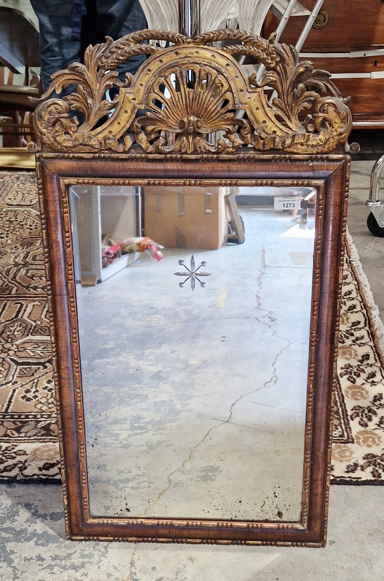 Continental stained wooden and gilt detailed wall mirror with carved and pierced shell and