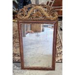 Continental stained wooden and gilt detailed wall mirror with carved and pierced shell and