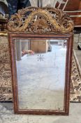 Continental stained wooden and gilt detailed wall mirror with carved and pierced shell and