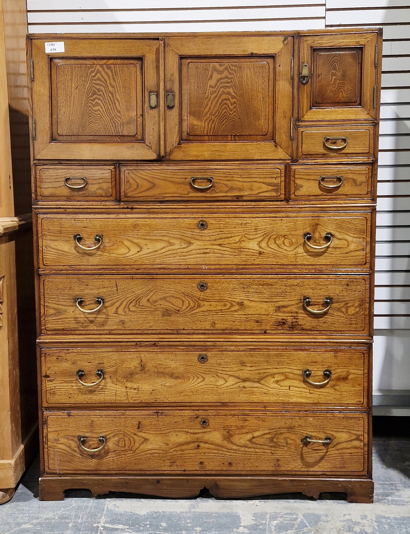 20th century stained wood three-section chest/storage cupboard with an array of drawers and three