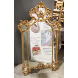 Gilt framed wall mirror with scrolling acanthus leaf motifs, 132cm high x 78cm wide