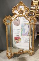 Gilt framed wall mirror with scrolling acanthus leaf motifs, 132cm high x 78cm wide