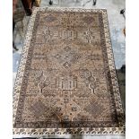 Eastern wool rug of caucasian design with mushroom brown field, having stepped lozenge to centre,