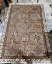 Eastern wool rug of caucasian design with mushroom brown field, having stepped lozenge to centre,