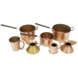 Set of three copper graduated saucepans with black stick  handles and a small quantity of copperware