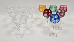 Harlequin coloured set of six cut hock glasses, each with tinted bowl engraved with starburst, on