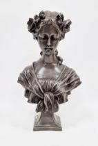 French-style silvered composition bust of girl with flowers in her hair, on waisted square base,