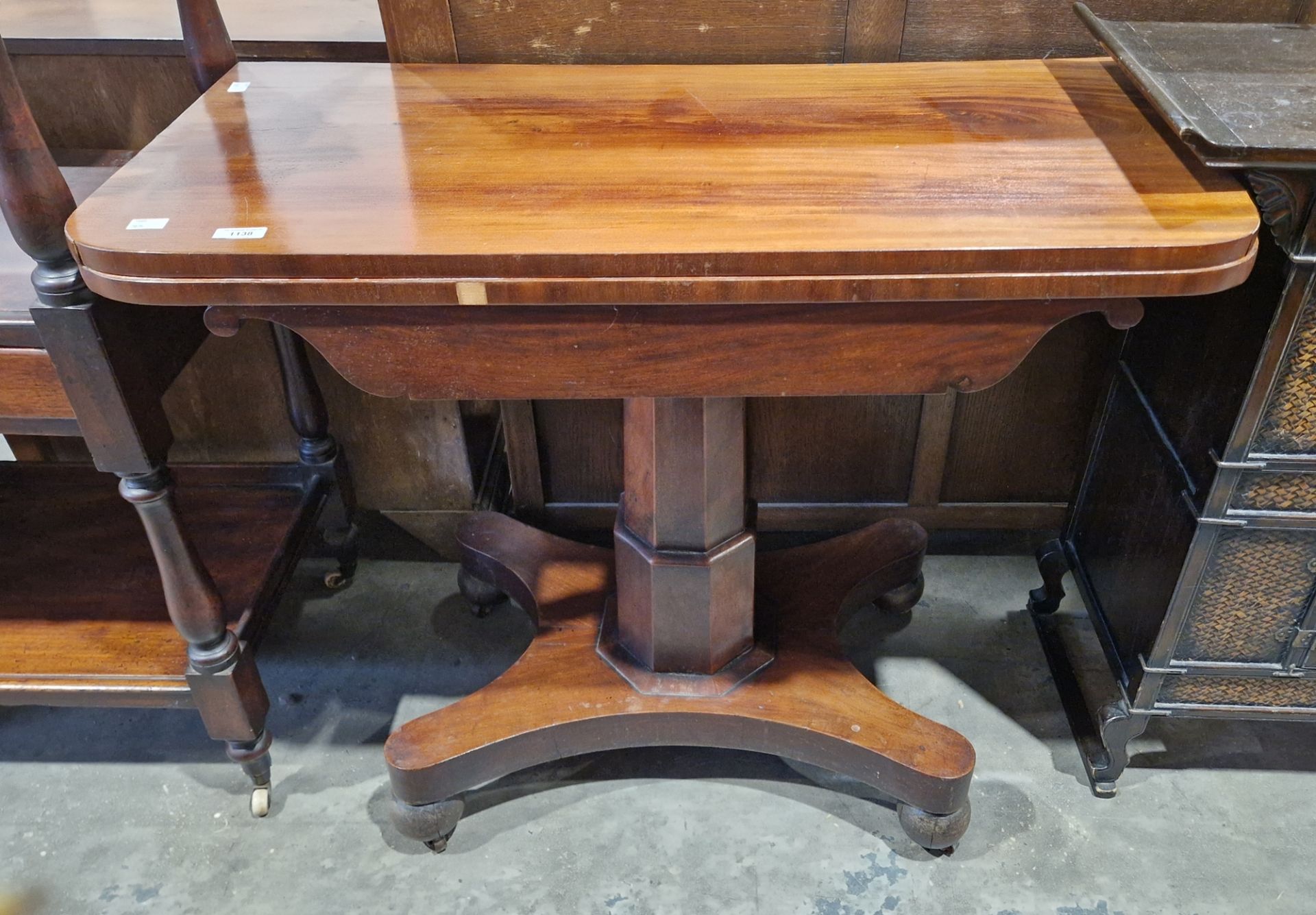 19th century mahogany folding afternoon tea table, rounded oblong, on octagonal column and concave