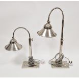 Pair chromium plated adjustable arched top table lamps with conical shades, on stepped rectangular