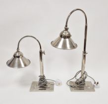 Pair chromium plated adjustable arched top table lamps with conical shades, on stepped rectangular