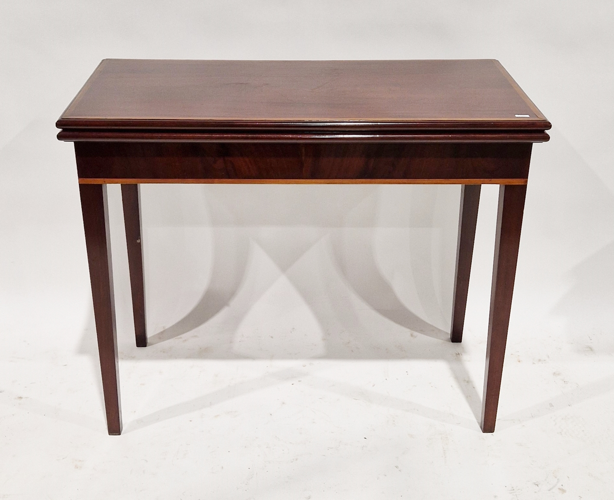 Georgian mahogany folding card table with satinwood inlaid border, opening to reveal a green baize
