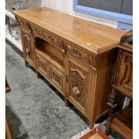 Late Victorian carved walnut sideboard of aesthetic movement design, having one short and two long