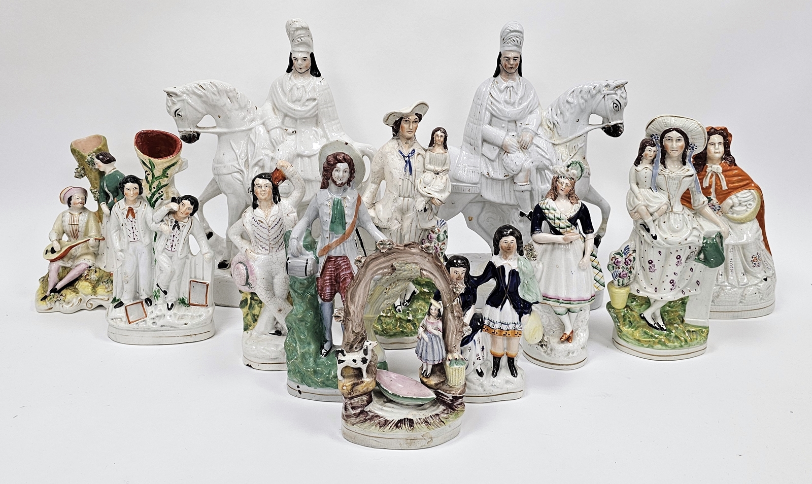Large collection of Victorian Staffordshire pottery flatback figures including a girl beneath a