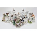 Large collection of Victorian Staffordshire pottery flatback figures including a girl beneath a