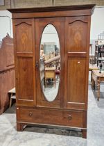 Edwardian mahogany single door wardrobe, the door with oval bevel edged mirror, inlaid marquetry and