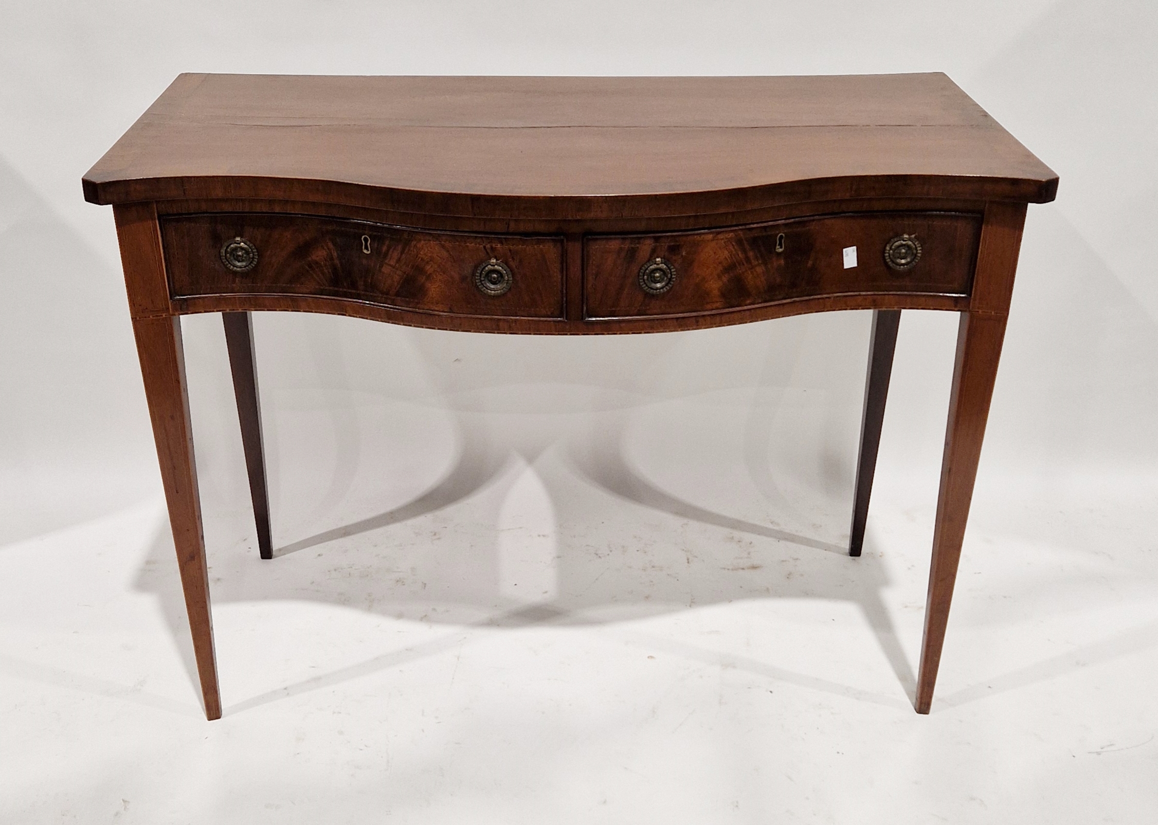 George III mahogany side table, serpentine-fronted with two frieze drawers with circular brass