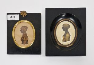 Two 19th century silhouette busts of ladies in period dress with gilt detailing, both mounted in