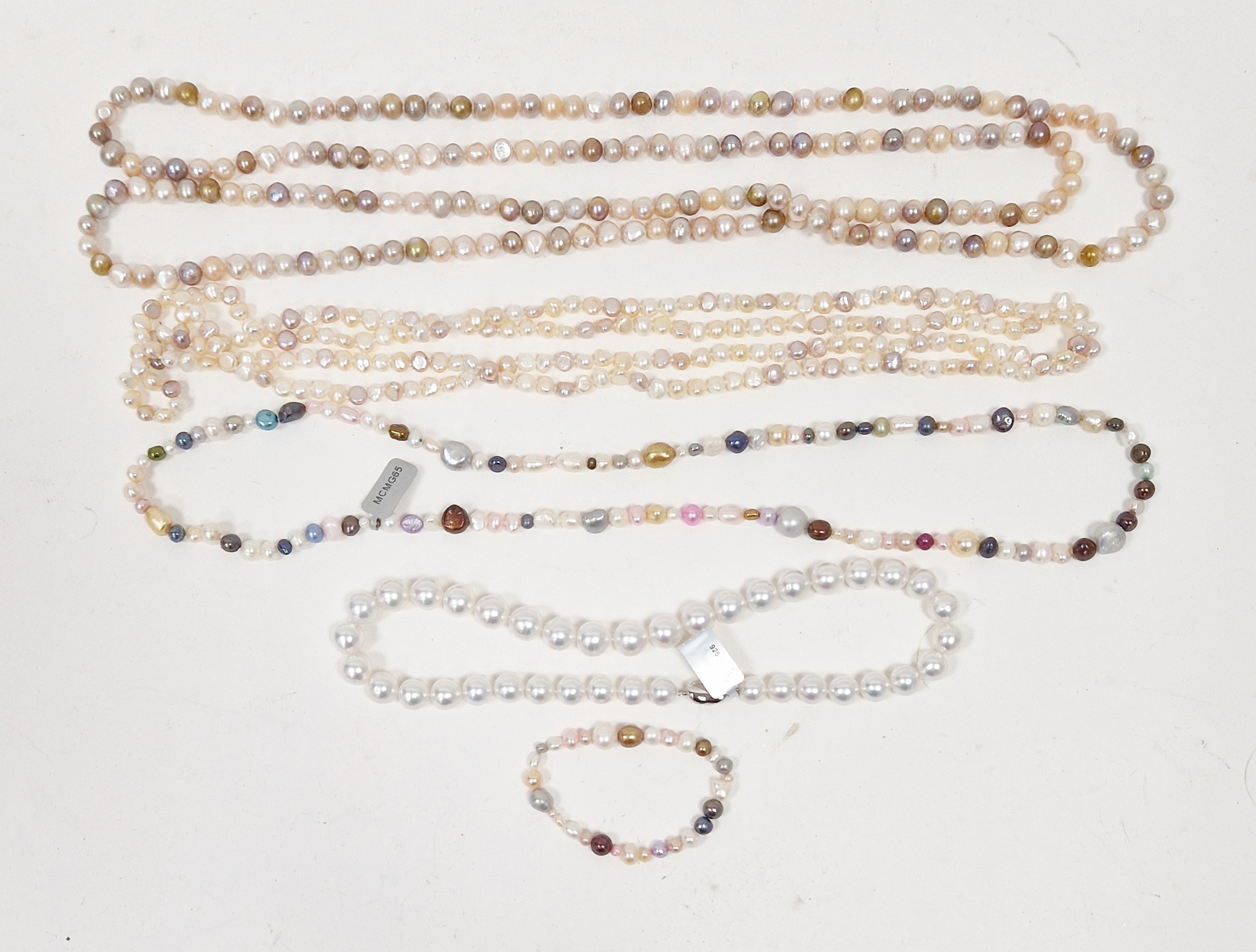 Two long strings of pink, cream and other coloured cultured pearls, a string of coloured cultured