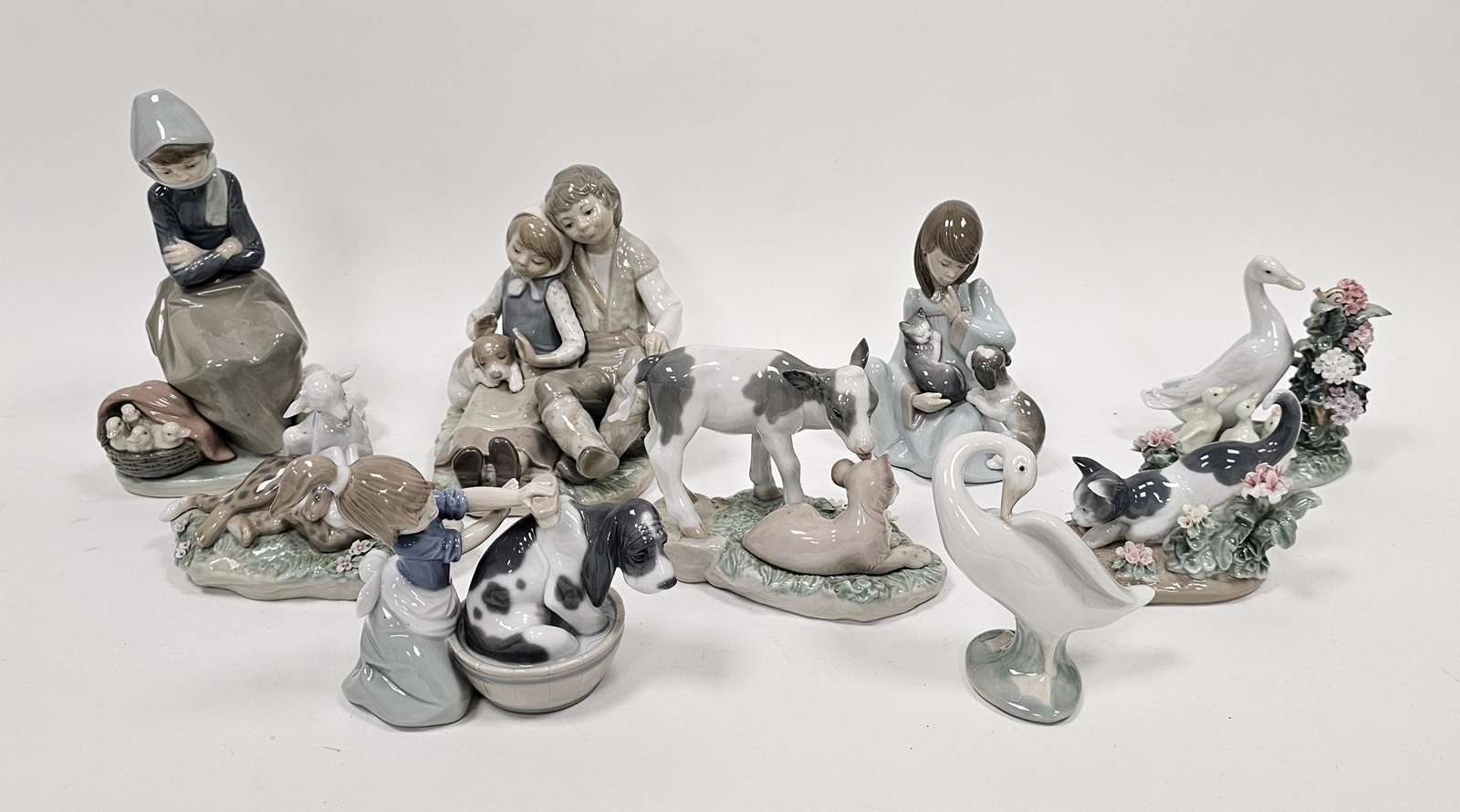 Nine Lladro figures of girls, boys and animals including a girl with kitten and puppy, another - Image 10 of 18