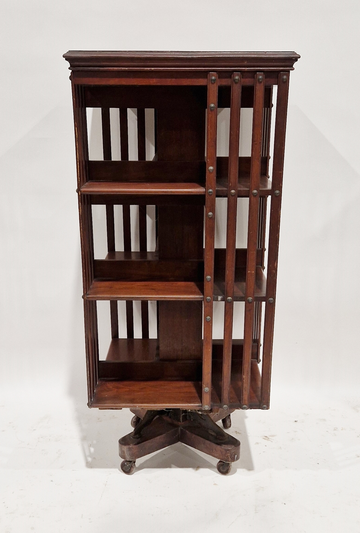 Early 20th century mahogany revolving bookcase, three tier, on castors, 110cm high x 50cm wide x
