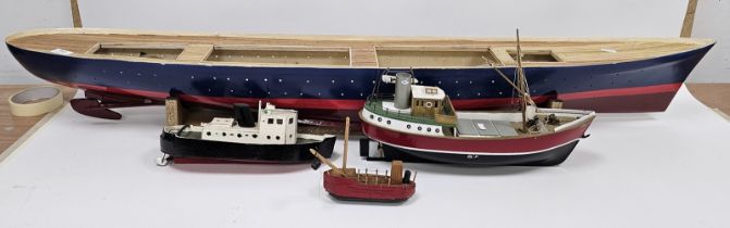 Painted wooden model boat on stand, unfinished and three other smaller boats (4)