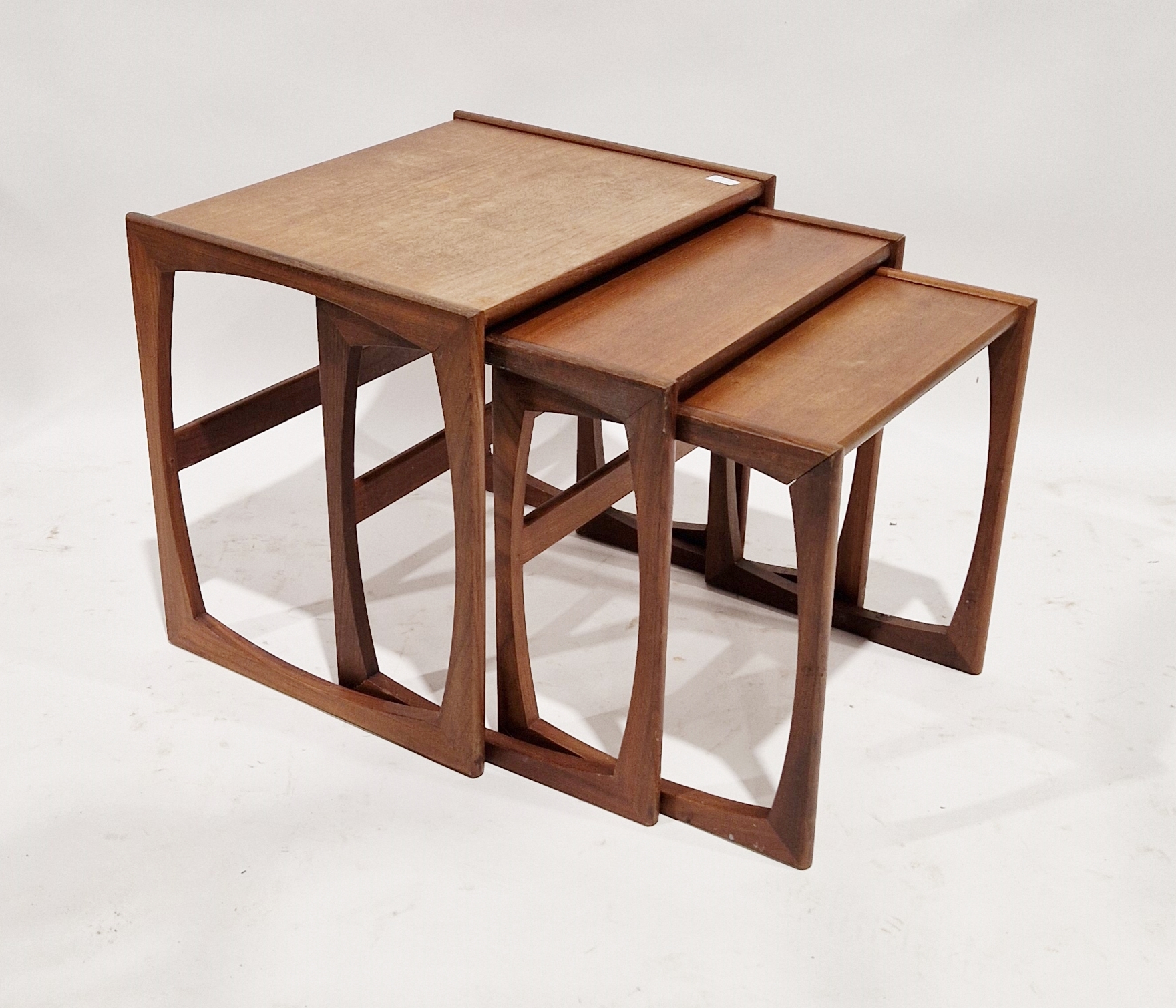 Nest of three G-Plan teak Quadrille tables with G-Plan labels to underside, in sizes, largest 49cm