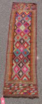 Eastern wool kelim runner with rows of chevrons centred by lozenges with greek key motifs in multi-