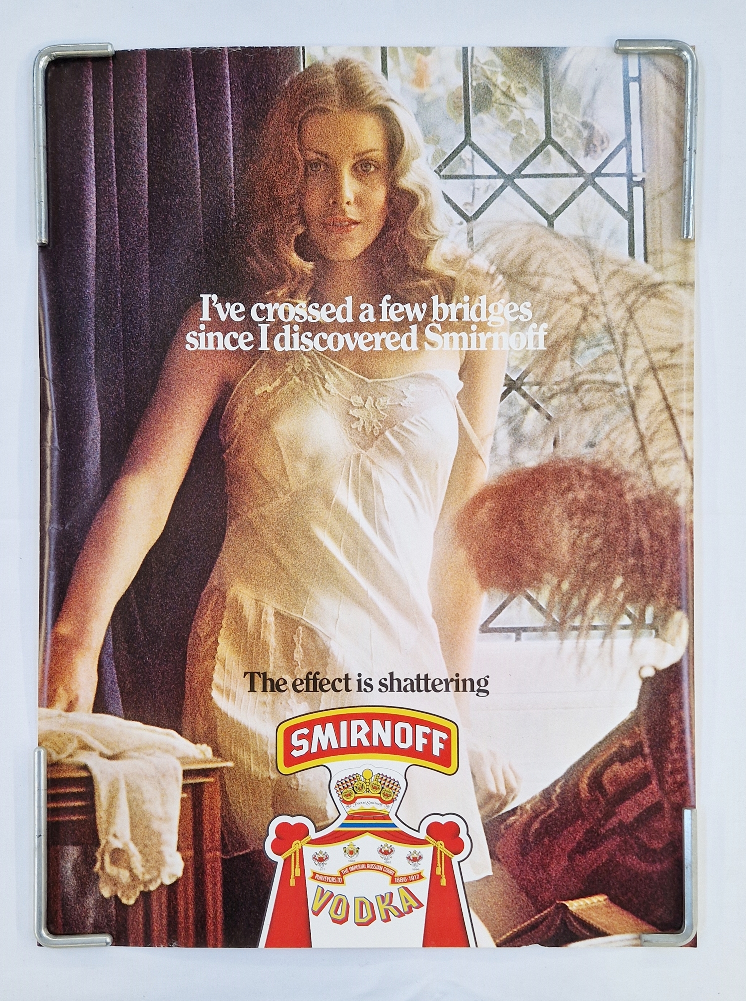 Two original vintage Smirnoff vodka advertising posters: "I've crossed a few bridges since I