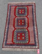 Eastern wool rug with three elephants foot guls, in red, blue and grey, having geometric