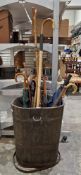 Collection of umbrellas, walking canes, a riding crop, alpine walking sticks, a Bisley folding seat,