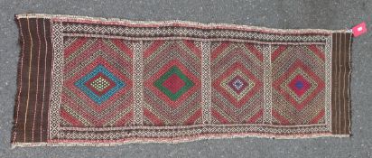 Eastern kelim runner with four lozenge filled sections and stripes to the ends, 190cm x 60cm