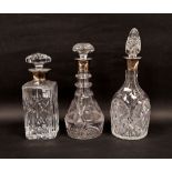 Three early 20th century silver-collared cut glass decanters and stoppers comprising a square
