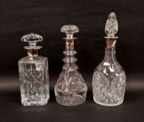 Three early 20th century silver-collared cut glass decanters and stoppers comprising a square