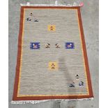 Indian wool grey ground rug with stylised animals and females to the field, single brown border