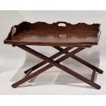 Mahogany butler's tray on folding X-frame stand, the tray with shaped three-quarter gallery and