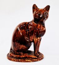 20th century pottery model of a cat, enriched in mottled brown Whieldon-style glaze, modelled seated