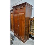 Large late Victorian mahogany two-door wardrobe containing a clothes rail and numerous coat hooks,