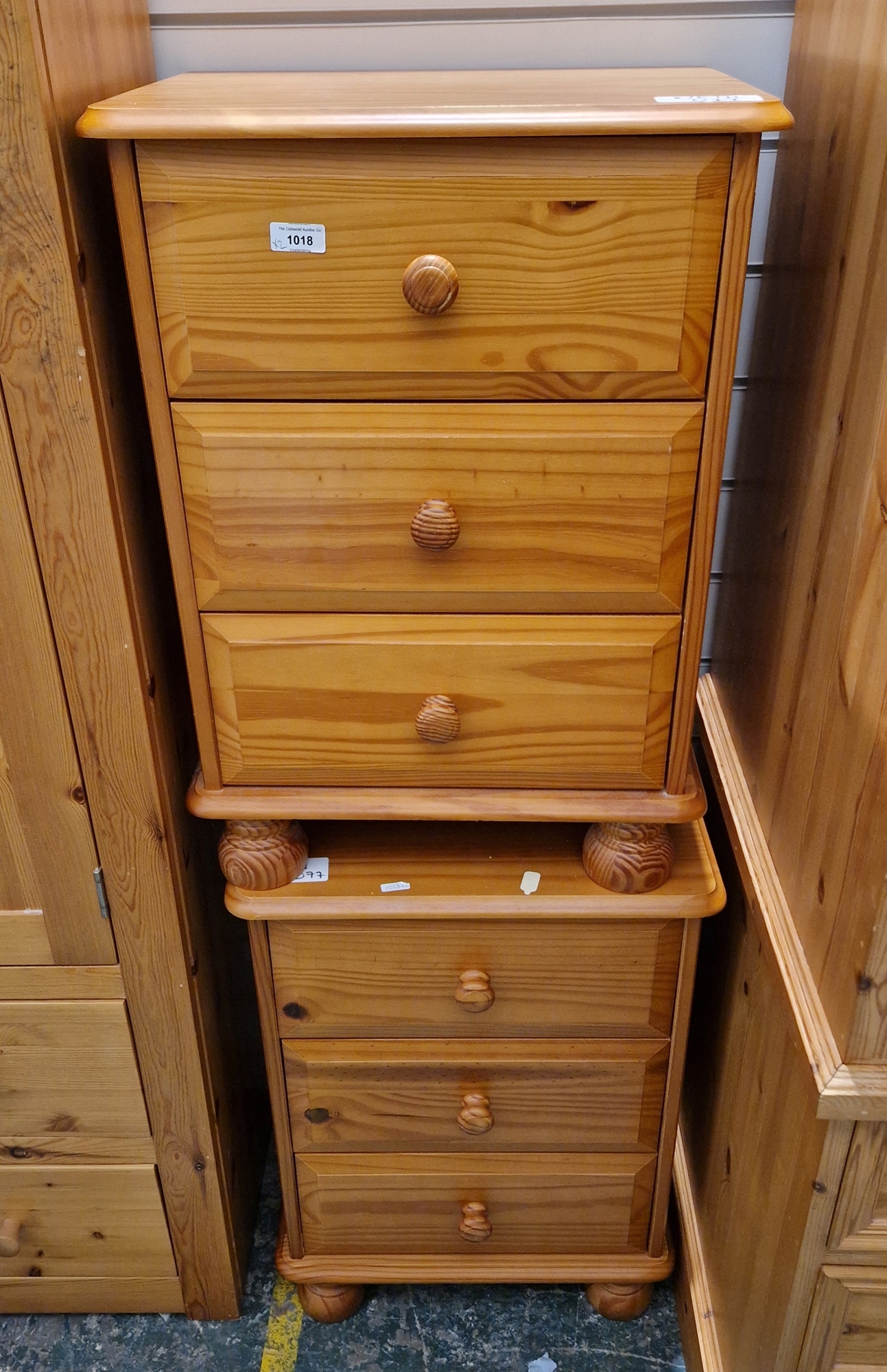 Pair of modern pine bedside chests of drawers, each with three short drawers, on bun feet, 62cm high