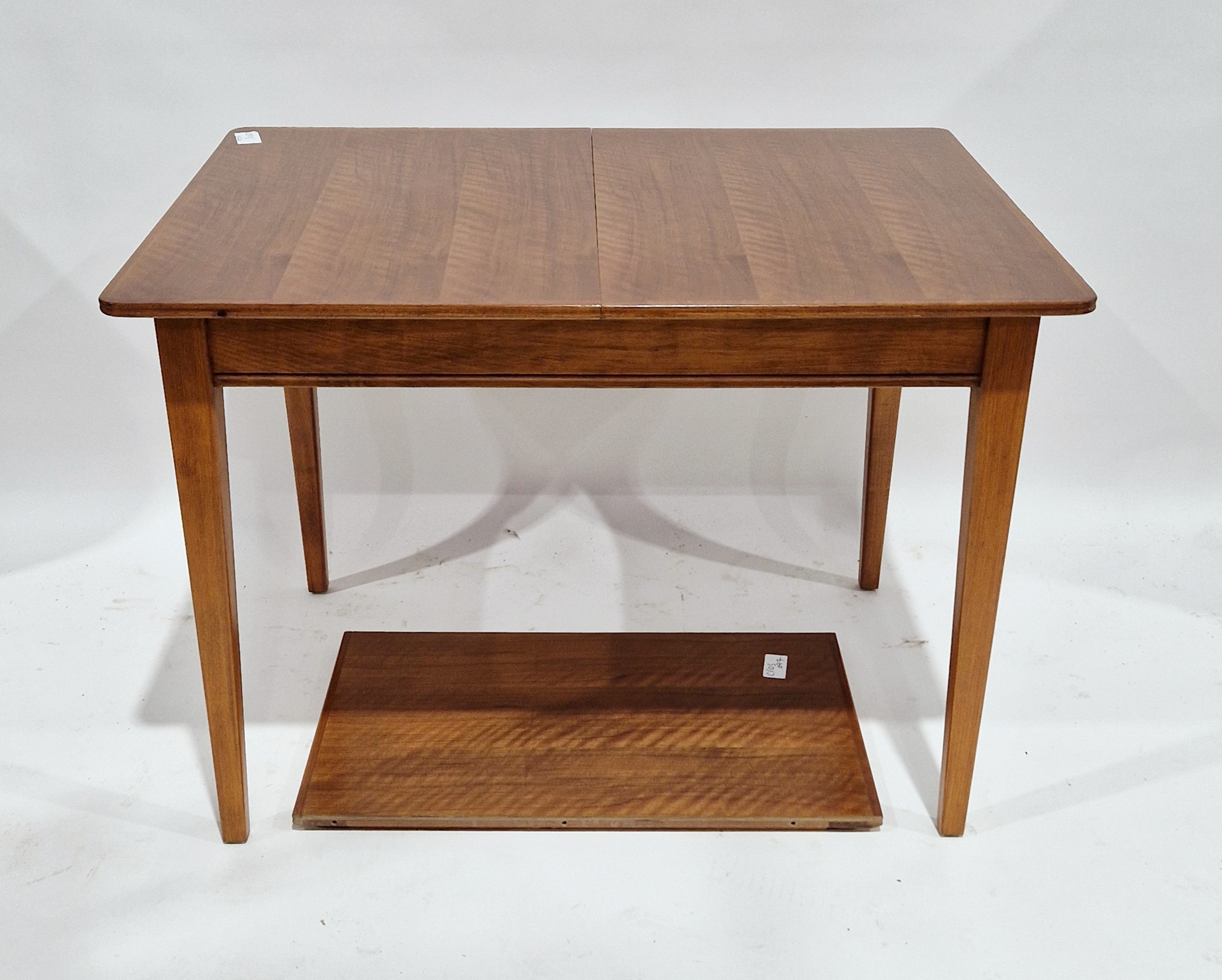 Gordon Russell of Broadway walnut extending dining table on square tapering legs, with single