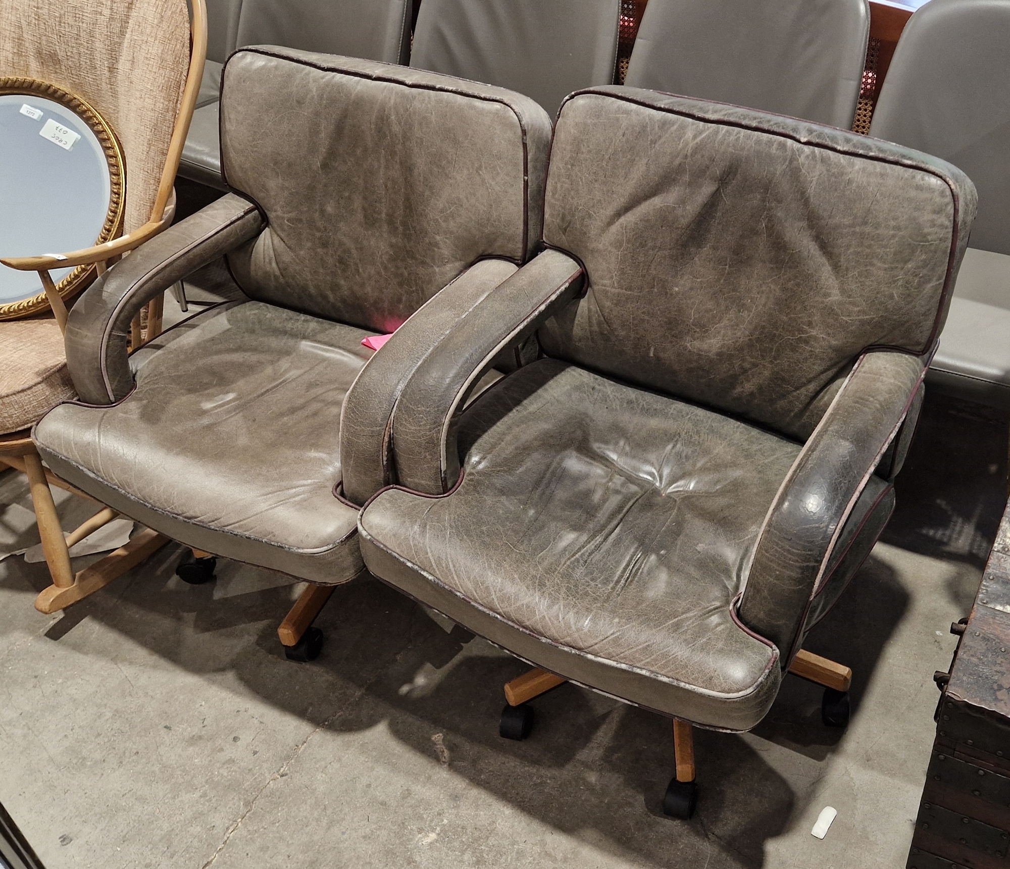 Two 20th century leather upholstered revolving armchairs on castors, 84cm high (2) - Image 2 of 2