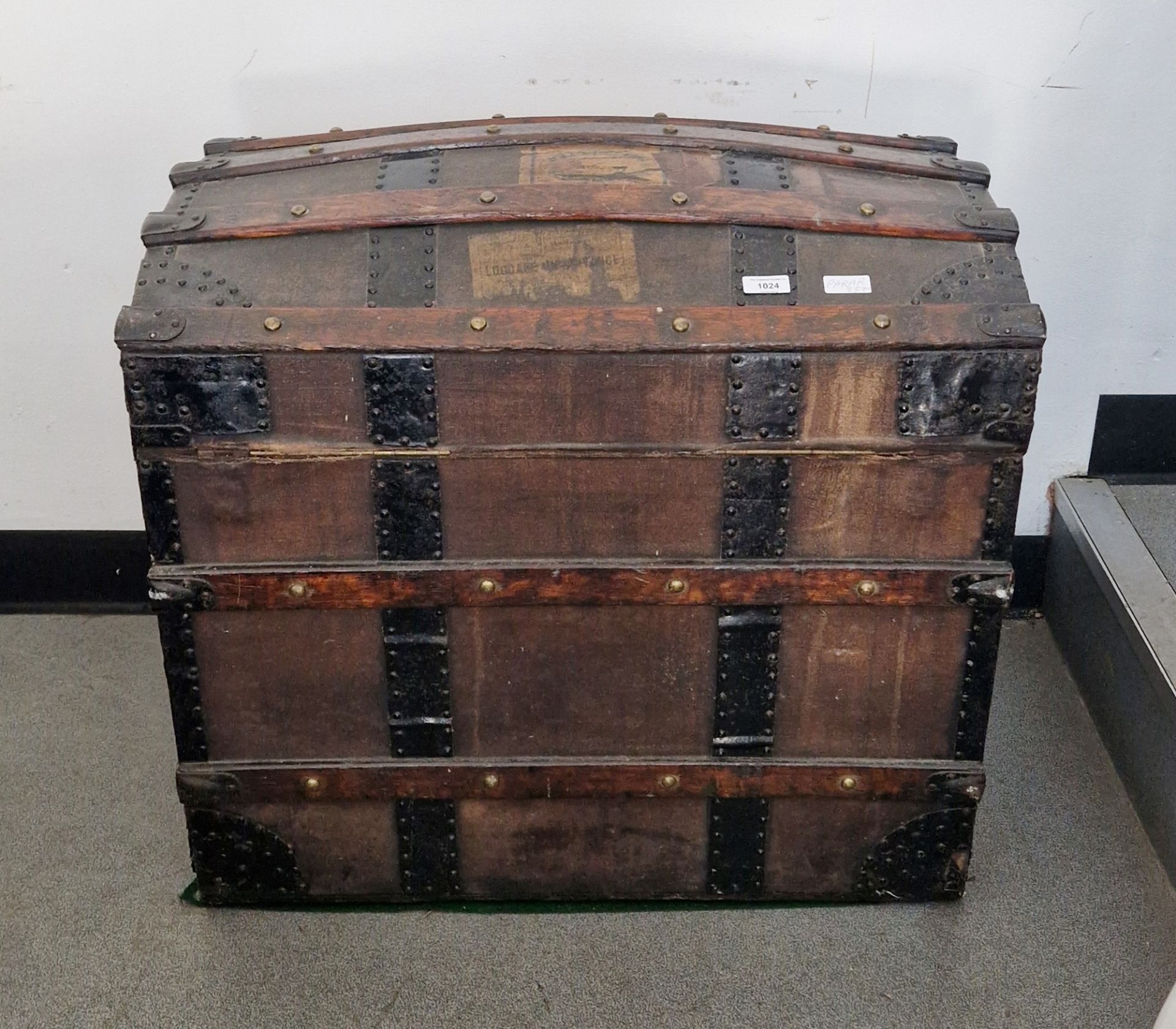 Late 19th century Finnigans dome-topped wooden bound trunk opening to reveal a fitted interior, 63cm