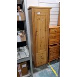 Modern pine storage cupboard having a large cupboard door opening to reveal various adjustable
