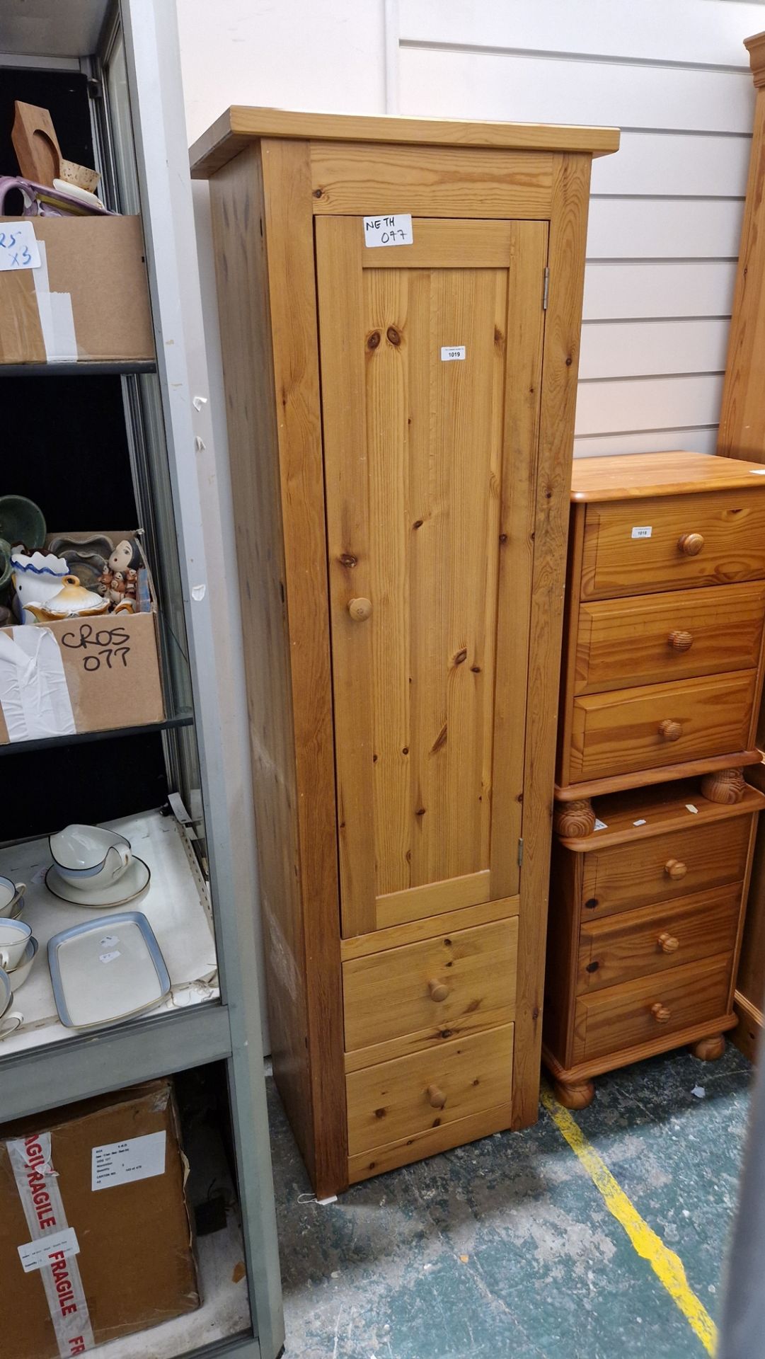 Modern pine storage cupboard having a large cupboard door opening to reveal various adjustable