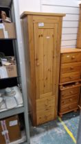 Modern pine storage cupboard having a large cupboard door opening to reveal various adjustable