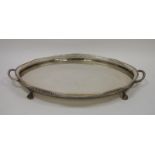 Large early 20th century oval two-handled EPNS galleried tray with beaded rim, raised on four paw