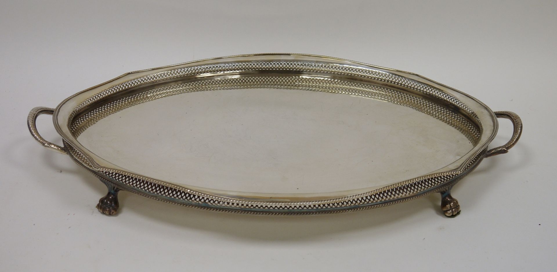 Large early 20th century oval two-handled EPNS galleried tray with beaded rim, raised on four paw