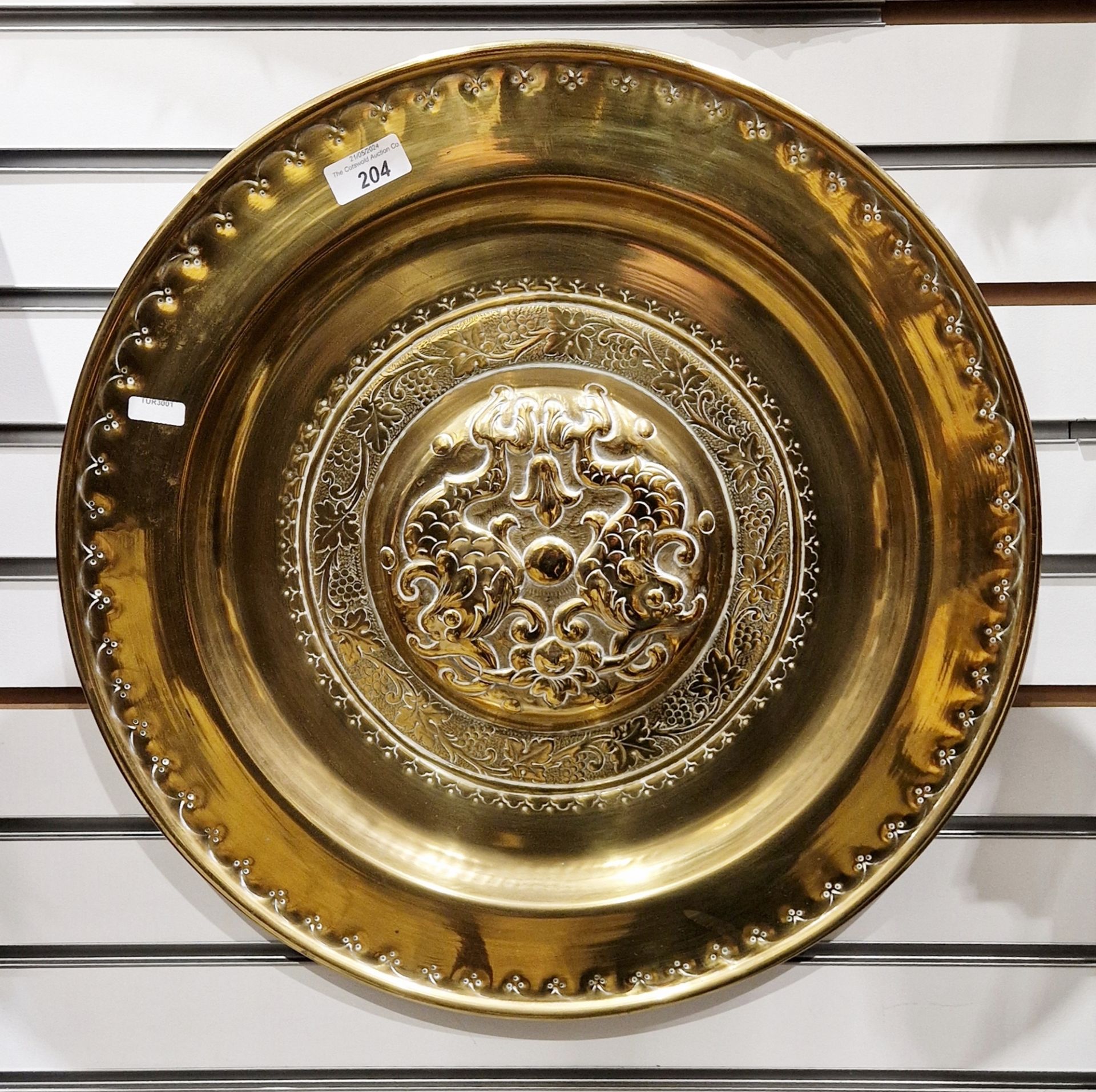 19th century continental embossed brass circular charger, the central boss decorated with stylised - Image 3 of 3